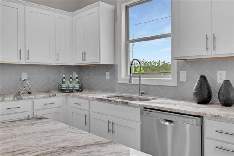 Granite countertops and island in the Parkview Landing model home kitchen