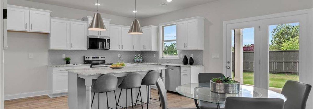 Kitchen with island and granite countertops in a Parkview Landing model home