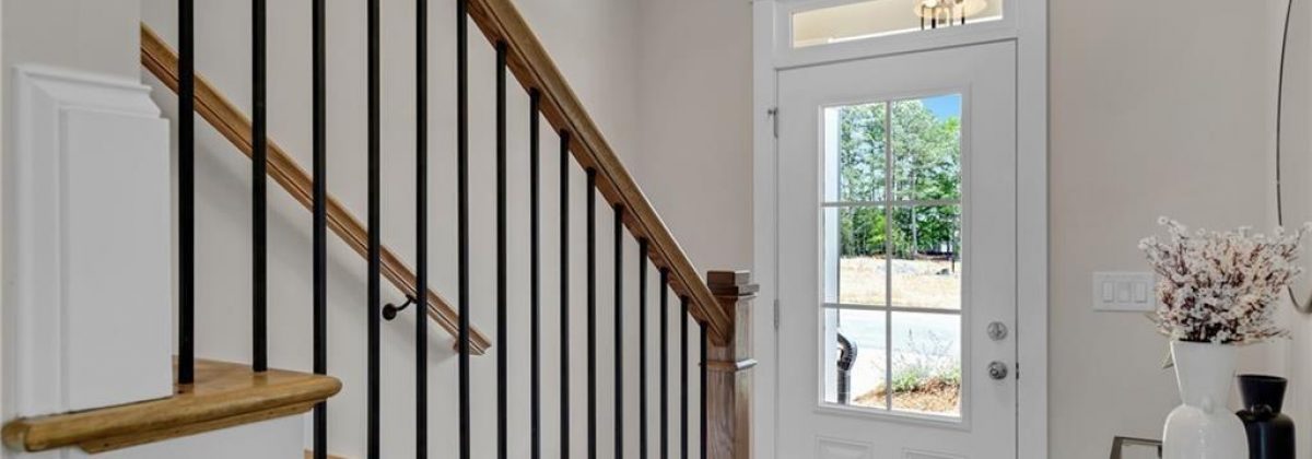 Foyer and staircase in a Parkview Landing model home by Three Rivers Homes